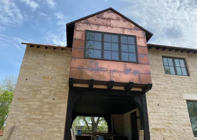 Copper metal panel facade on a stone building for Skylight Installation in Etowah