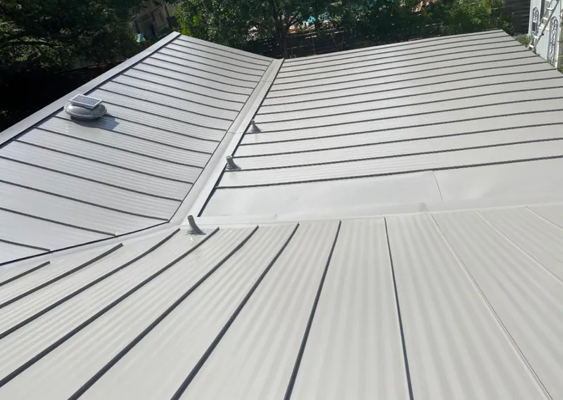 Solar attic fan installed on a metal roof for Roof Ventilation in Etowah
